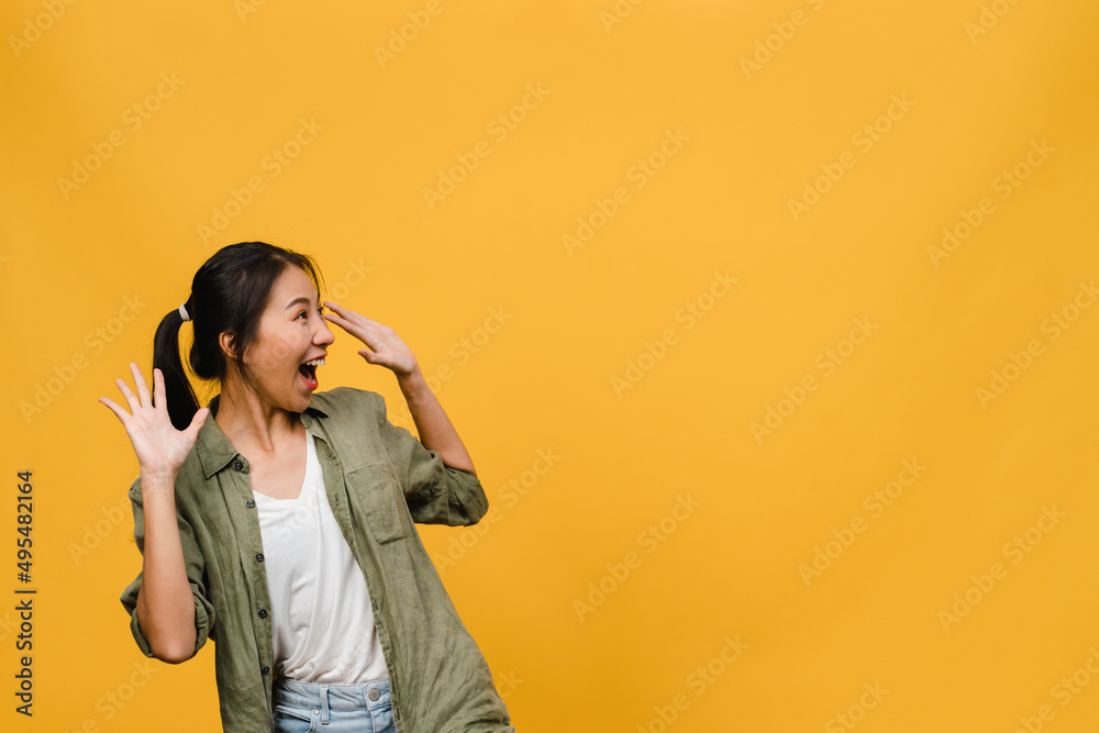 Young Asia lady feel happiness with positive expression, joyful surprise funky, dressed in casual cloth isolated on yellow background. Happy adorable glad woman rejoices success. Facial expression. Young Asia lady feel happiness with positive expression, joyful surprise funky, dressed in casual cloth isolated on yellow background. Happy adorable glad woman rejoices success. Facial expression.