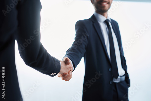 young businessman shaking hands with his business partner.