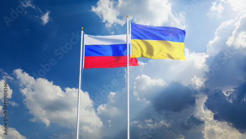 Ukraine and Russian flags waving on beautiful sky background. CG Image. Russia and Ukraine relations. Ukraine and Russia flags together