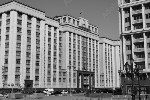 Black and white photography. View of the building of the State Duma in Moscow. Above the entrance there is an inscription in Russian STATE DUMA. March 24, 2022, Moscow, Russia.