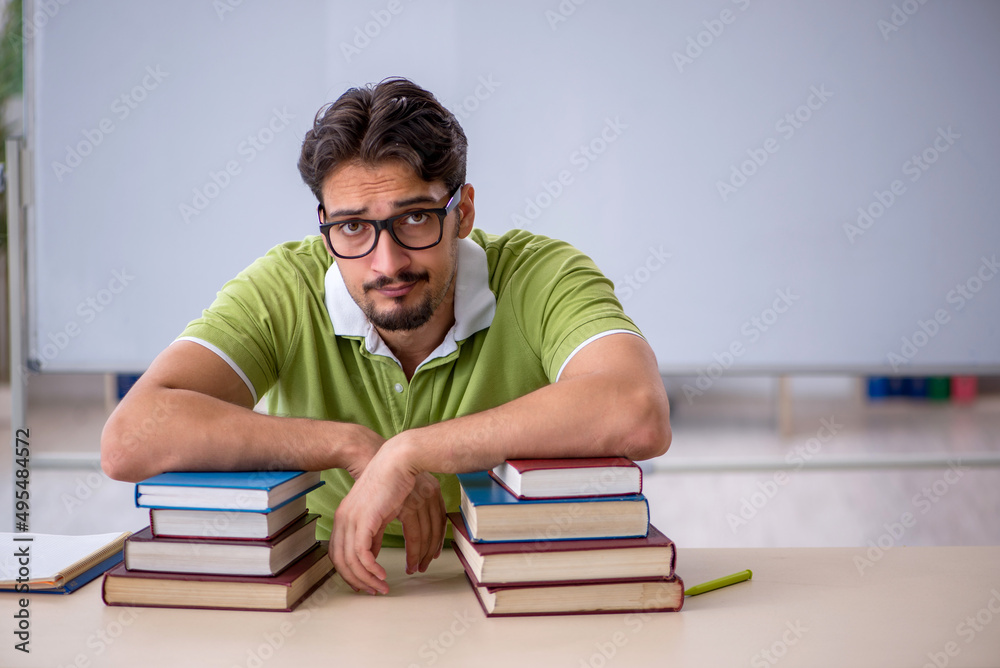 Young male student preparing for exams in the classroom Young male student preparing for exams in the classroom