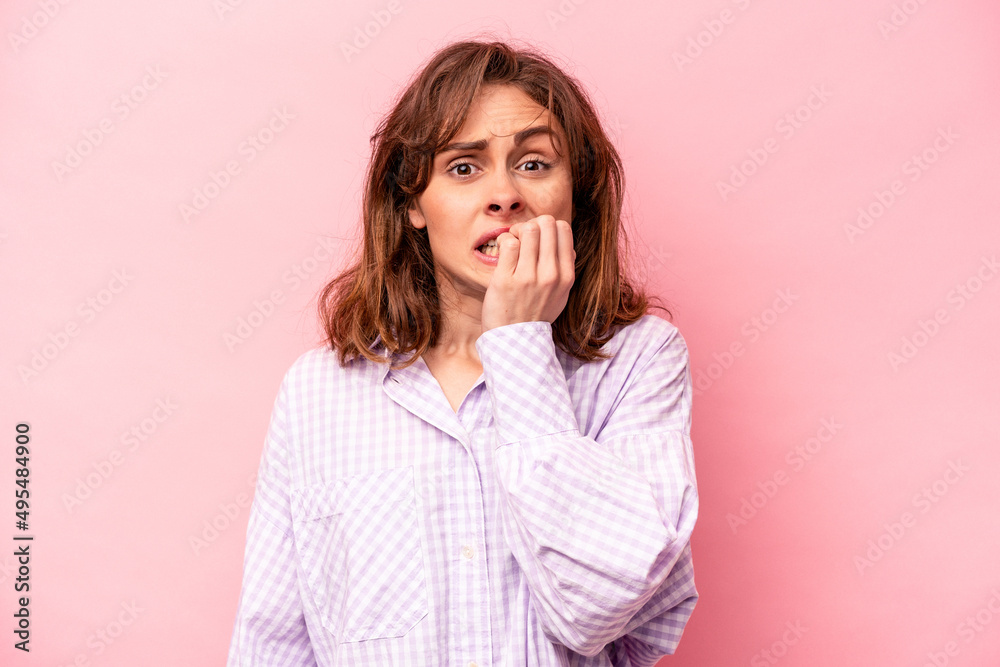 Young caucasian woman isolated on pink background biting fingernails, nervous and very anxious. Young caucasian woman isolated on pink background biting fingernails, nervous and very anxious.