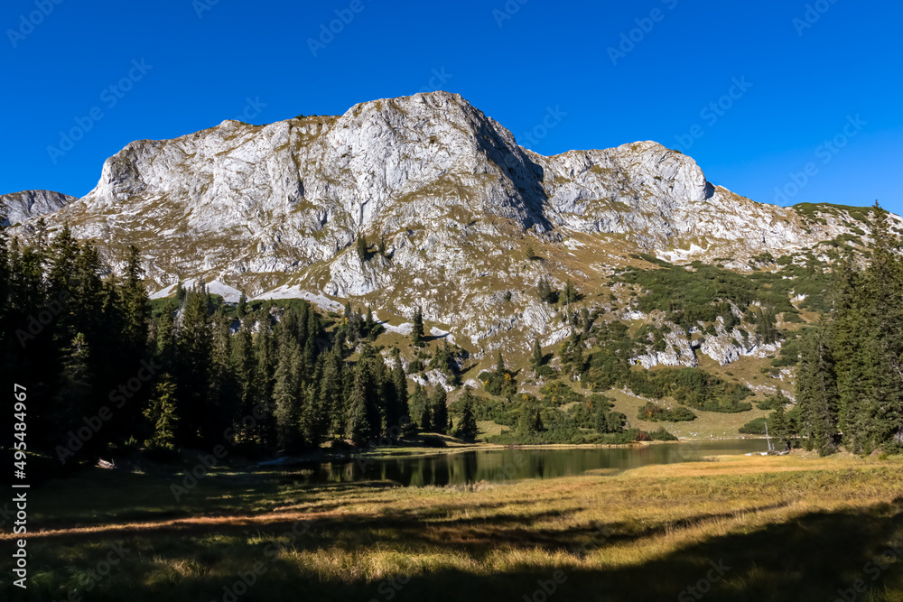 Panoramic view on lake Sackwiesensee and mountain peaks of the Hochschwab Region in Upper Styria, Austria. Sharp summits of Seemauer, Polster, Oehler in the Alps in Europe. Wilderness. Concept freedom