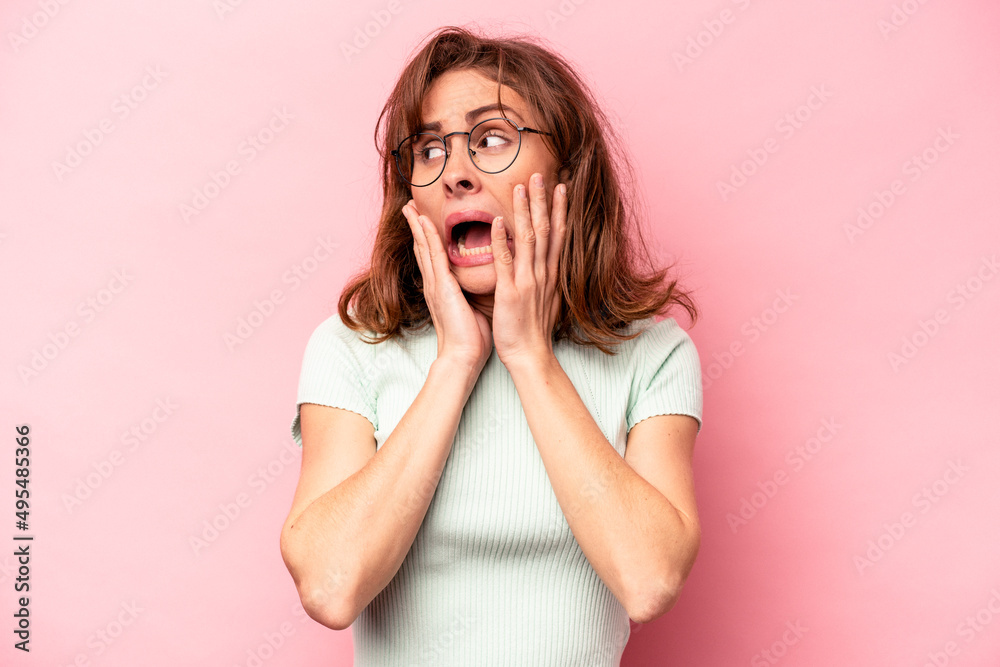 Young caucasian woman isolated on pink background scared and afraid. Young caucasian woman isolated on pink background scared and afraid.