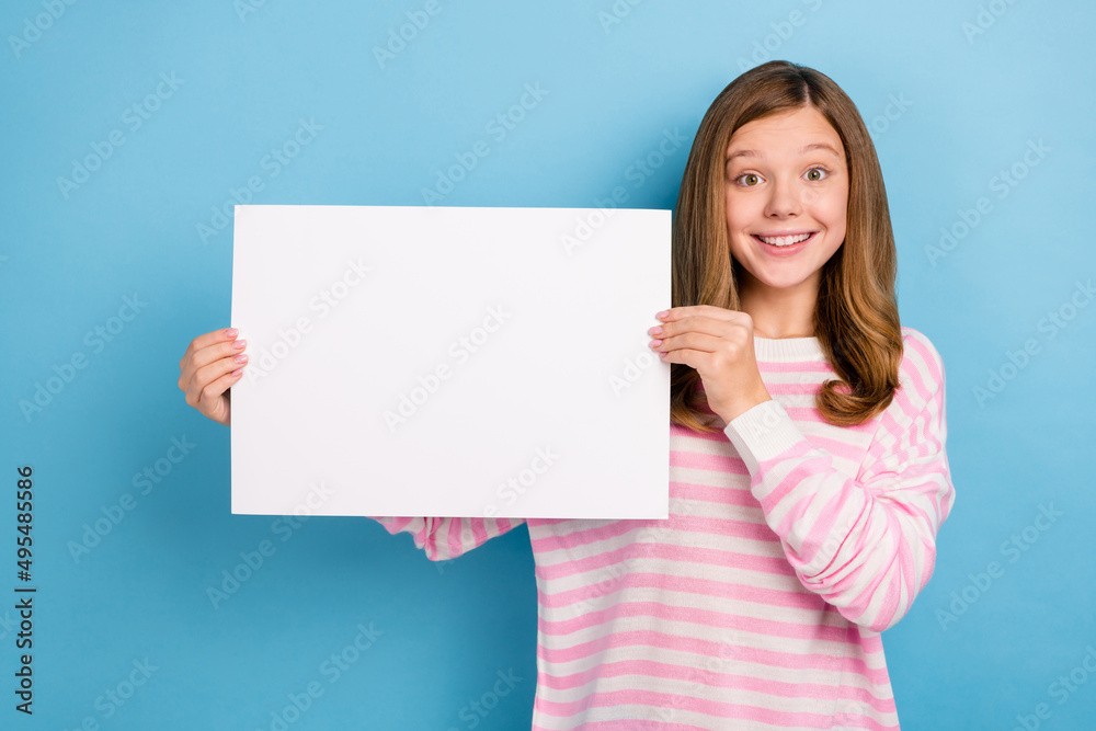 Photo of friendly positive person hold demonstrate empty space list isolated on blue color background Photo of friendly positive person hold demonstrate empty space list isolated on blue color background