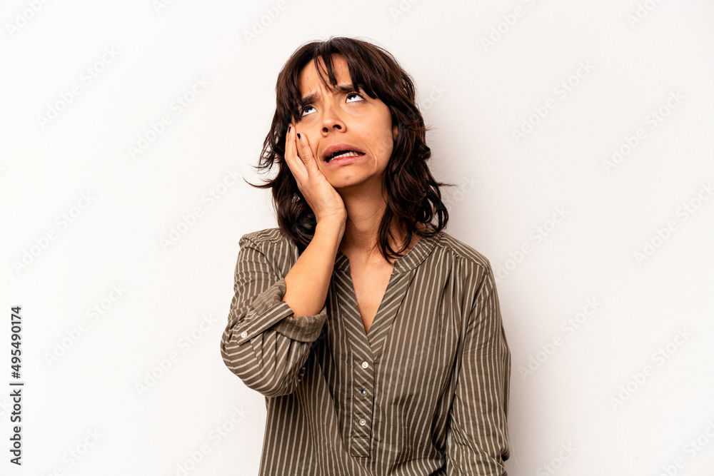 Young hispanic woman isolated on white background tired and very sleepy keeping hand on head.