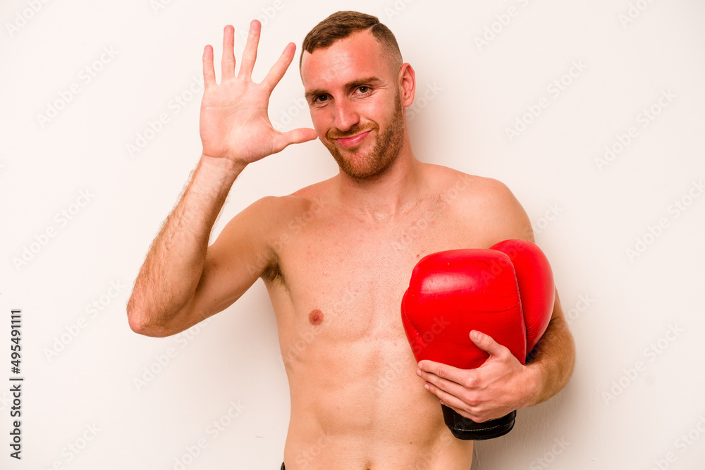 Young caucasian man doing boxing isolated on white background smiling cheerful showing number five with fingers. Young caucasian man doing boxing isolated on white background smiling cheerful showing number five with fingers.