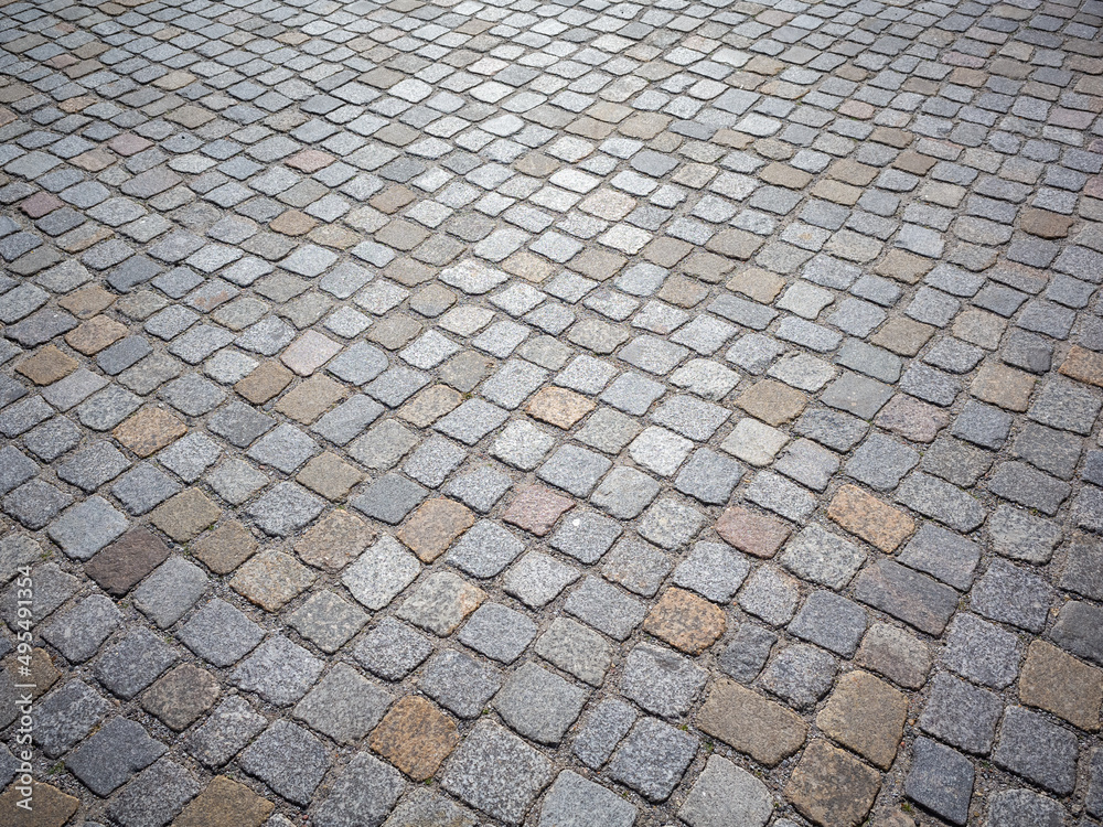 cobblestone surface of a city square. 
gray paved road or driveway.