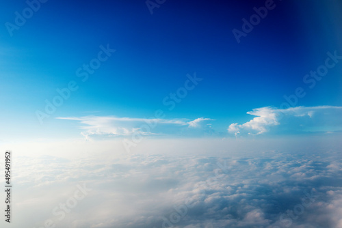 Blue sky and white cloud from airplane window © xy