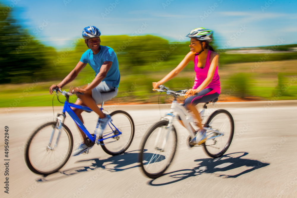 African American couple keeping fit riding bikes together