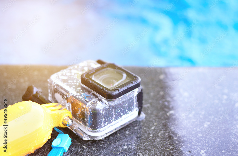 action camera in waterproof housing beside outdoor swimming pool action camera in waterproof housing beside outdoor swimming pool