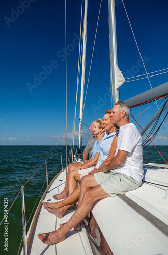 Retired friends enjoying luxury outdoor lifestyle on yacht
