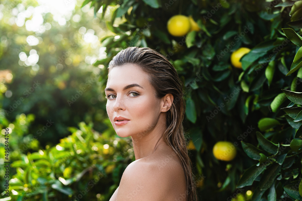 Portrait of beautiful woman with smooth skin against lemon trees Portrait of beautiful woman with smooth skin against lemon trees