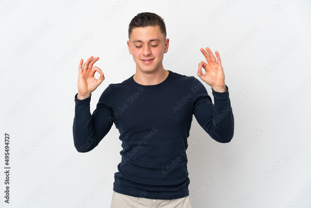 Young caucasian man isolated on white background in zen pose Young caucasian man isolated on white background in zen pose