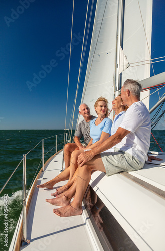 Senior American friends relaxing together on luxury yacht
