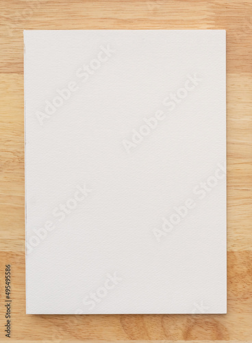 White cover of sketching book on wood for art background.