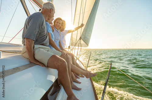 Relaxed group of senior friends sailing luxury yacht