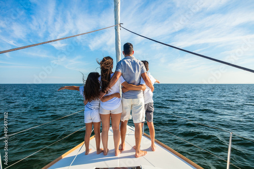 Young Latino family standing together on private yacht