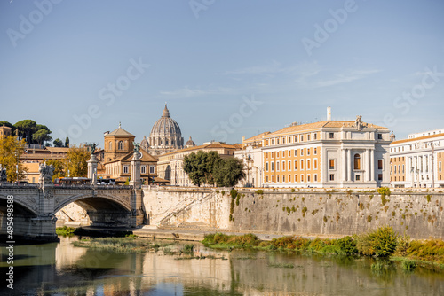 Landscape of Tiber river at sunny morning in Rome. Dome of famous saint Peter basalica on the skyline. Traveling Italy photo