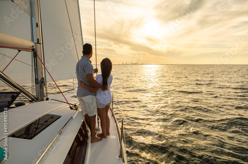 Hispanic couple travelling on luxury yacht at sunset © Spotmatik