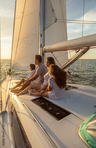Latin American family relaxing on yacht at sunset © Spotmatik