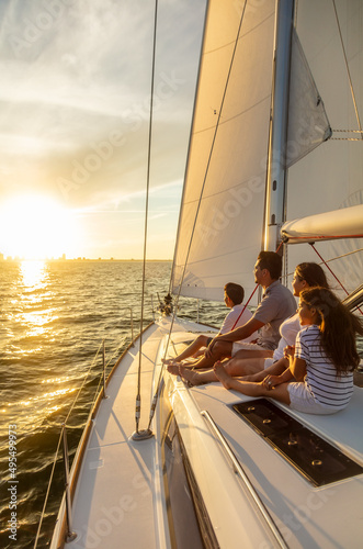 Hispanic family enjoying ocean sunset from luxury yacht © Spotmatik