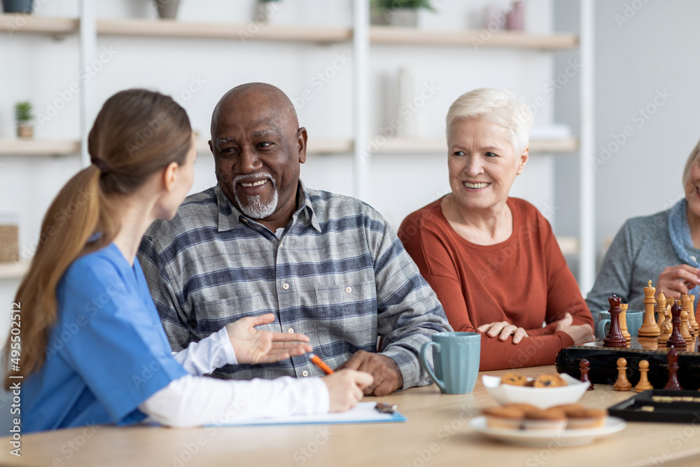 Nurse having conversation with african american senior man Nurse having conversation with african american senior man