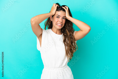 Young caucasian woman isolated on blue background doing nervous gesture