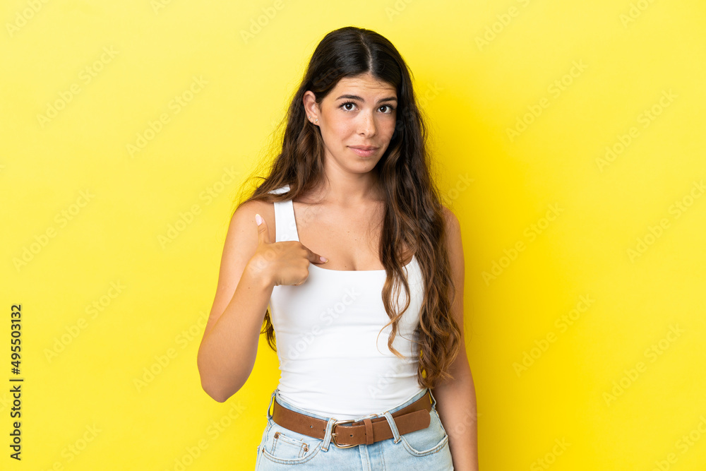 Young caucasian woman isolated on yellow background pointing to oneself Young caucasian woman isolated on yellow background pointing to oneself