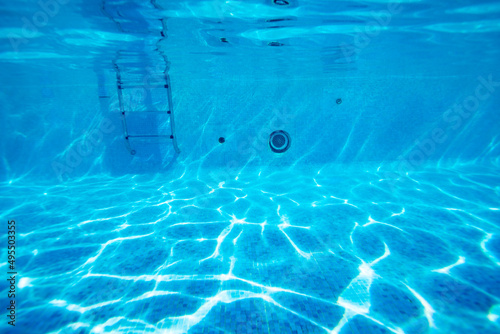 Underwater pool floor photo of rails and ladder stairs
