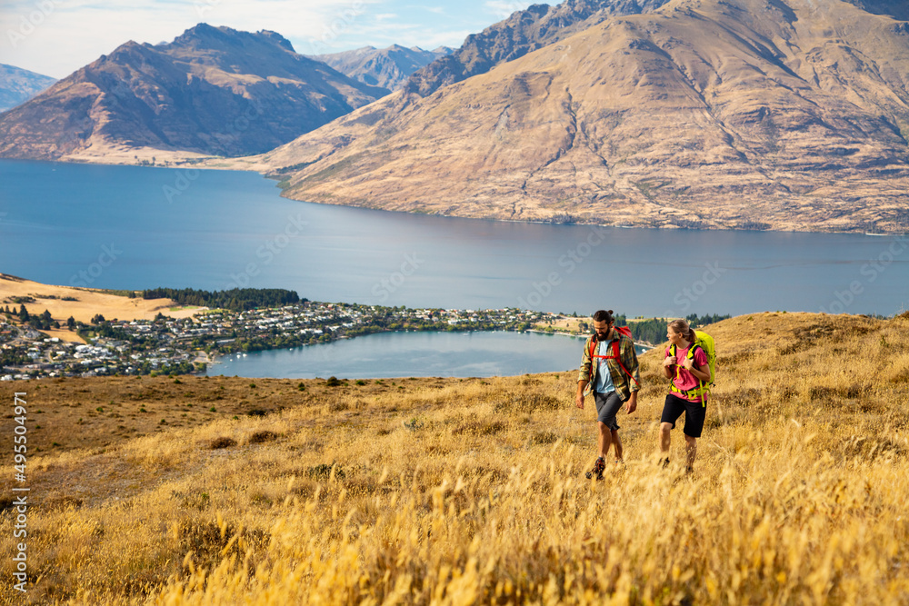The Remarkables young Caucasian couple trekking Lake Wakatipu