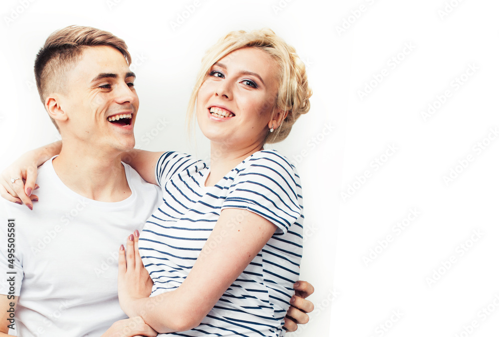 young pretty teenage couple, hipster guy with his girlfriend happy smiling and hugging isolated on white background, lifestyle people concept