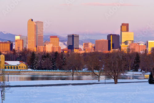 Denver City Park Dawn - Denver downtown skyline as sun turns high rise glass a golden color with a purple tinted sky above the mountains. © Jon Camrud