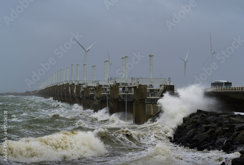 Netherlands, Vrouwenpolder, Sea waves crashing against pier during storm Corrie