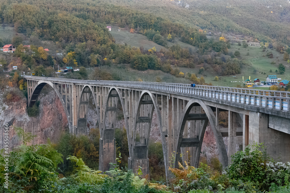 Tara Bridge in Montenegro with autumn colors and blue sky on a sunny day Tara Bridge in Montenegro with autumn colors and blue sky on a sunny day