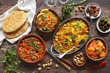 Traditional African dishes assortment. Chakalaka, Ethiopian Cabbage, Couscous salad, Carrot and citrus fruits salad. Selective focus