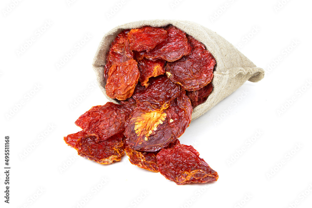 Dried tomatoes in a sack isolated on a white background. Sun dried tomatoes in jute bag.Healthy food