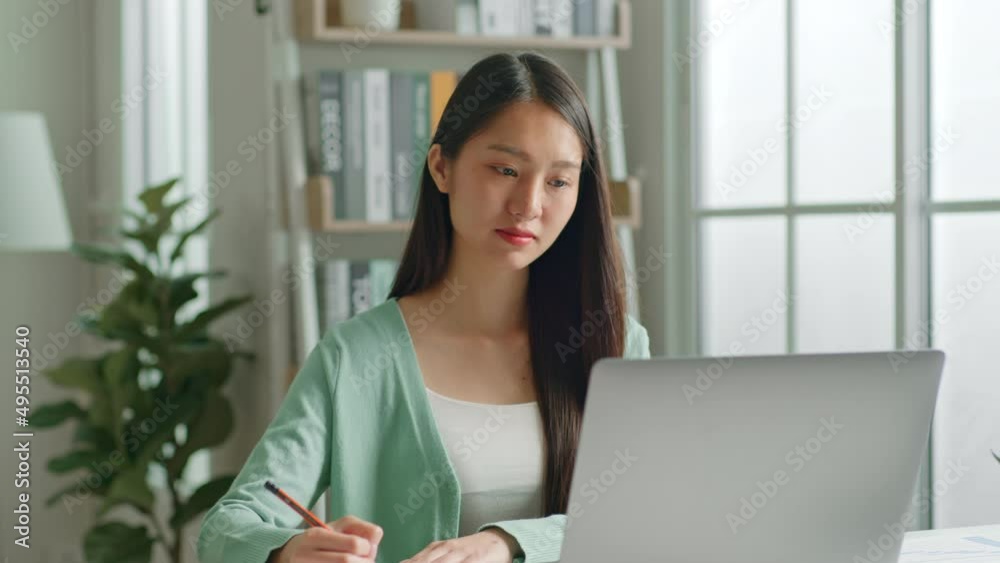 Young Asian woman using laptop computer for online working, studying, learning chatting in social media at home. Young Asian woman using laptop computer for online working, studying, learning chatting in social media at home.