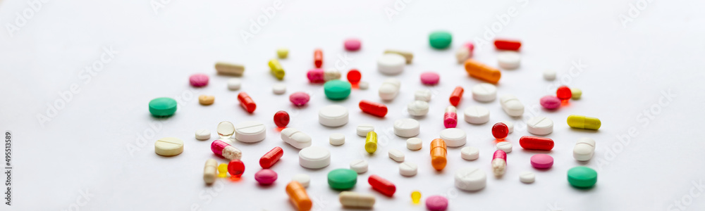 Creative layout of colorful pills and capsules on green background. Minimal medical concept. Pharmaceutical, Covid-19. Flat lay.Medication and prescription pills . Virus epidemic. Creative layout of colorful pills and capsules on green background. Minimal medical concept. Pharmaceutical, Covid-19. Flat lay.Medication and prescription pills . Virus epidemic.