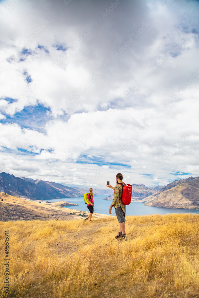 Successful couple taking picture Lake Wakatipu South Island