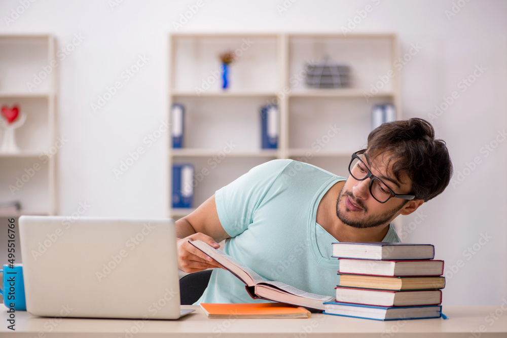 Young male student preparing for exams in the classroom Young male student preparing for exams in the classroom