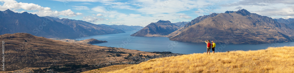 Panoramic travel hikers viewing Lake Wakatipu New Zealand