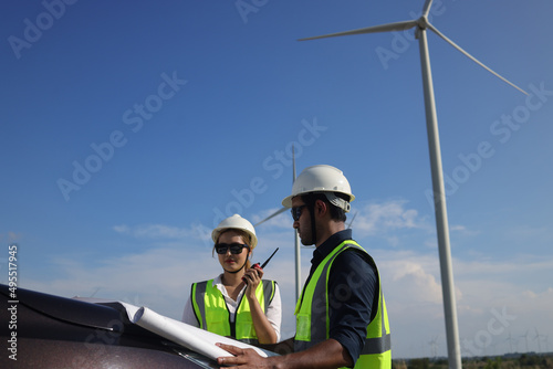  Two engineer colleage read drawing working on front vehicle, Wind turbine green energy photo
