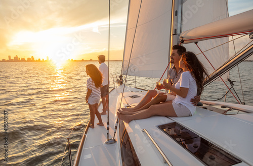 Latino family with luxury lifestyle sailing at sunset