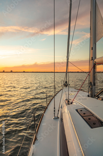 Sailing on luxury yacht towards cityscape at sunset © Spotmatik