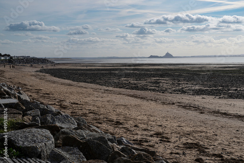 Obraz na plátně Silhouette of Mont Saint Michel in the distance from a beach in Normandy