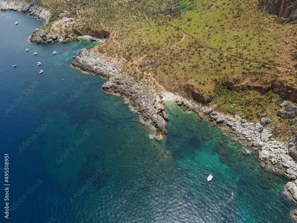 Drone aerial above beautiful coastline, turquoise clear sea water, wild nature, Zingaro Nature Reserve, Sicily. Tropical travel holiday near Scopello.