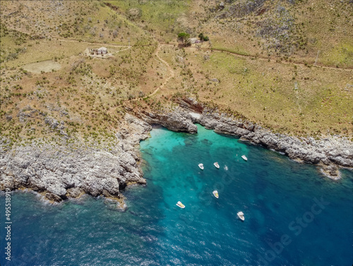 Drone aerial above beautiful coastline, turquoise clear sea water, wild nature, Zingaro Nature Reserve, Sicily. Tropical travel holiday near Scopello.