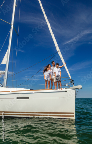 Young Hispanic family standing together on private yacht © Spotmatik