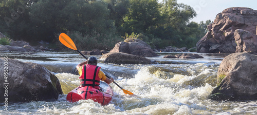 Photography A man rowing inflatable packraft on whitewater of mountain river